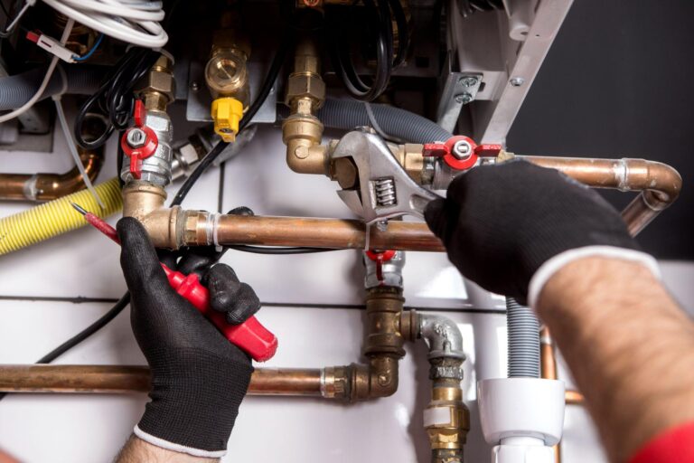 Plumber fixing central heating system